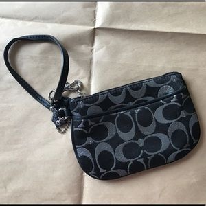 Black and silver Coach wristlet.